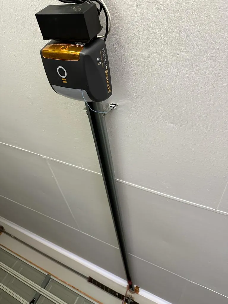 Ceiling mounted garage door opener and rail
