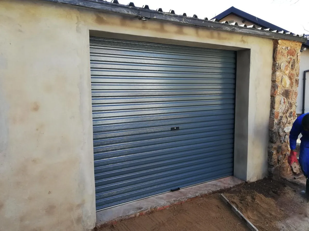Charcoal roll-up garage door at a residential entrance