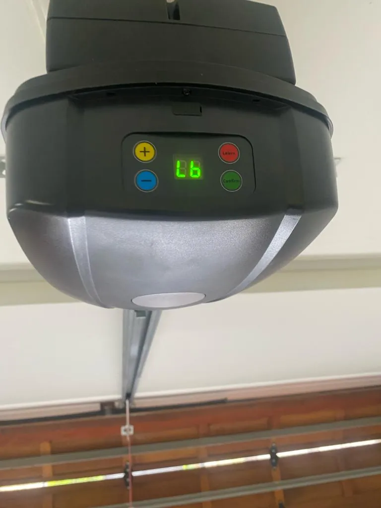 Installed garage door motor with control buttons and a status display