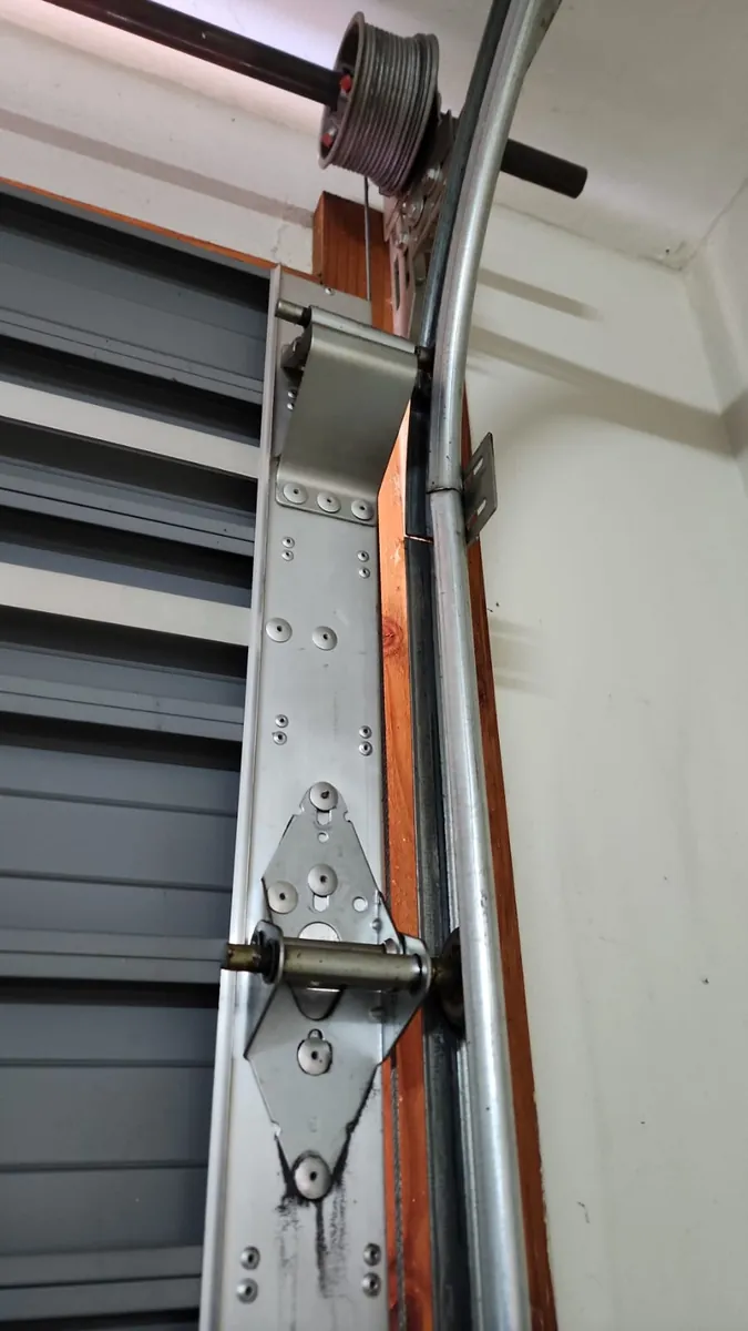 Garage door cable and side hardware along the track
