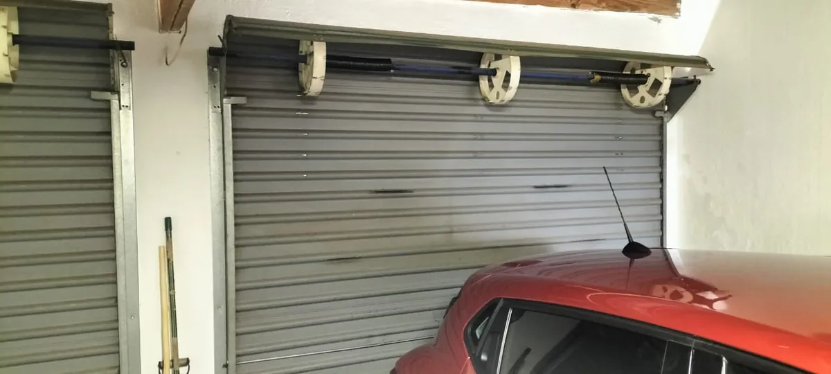 Interior of a residential roll-up garage door showing the curtain roll