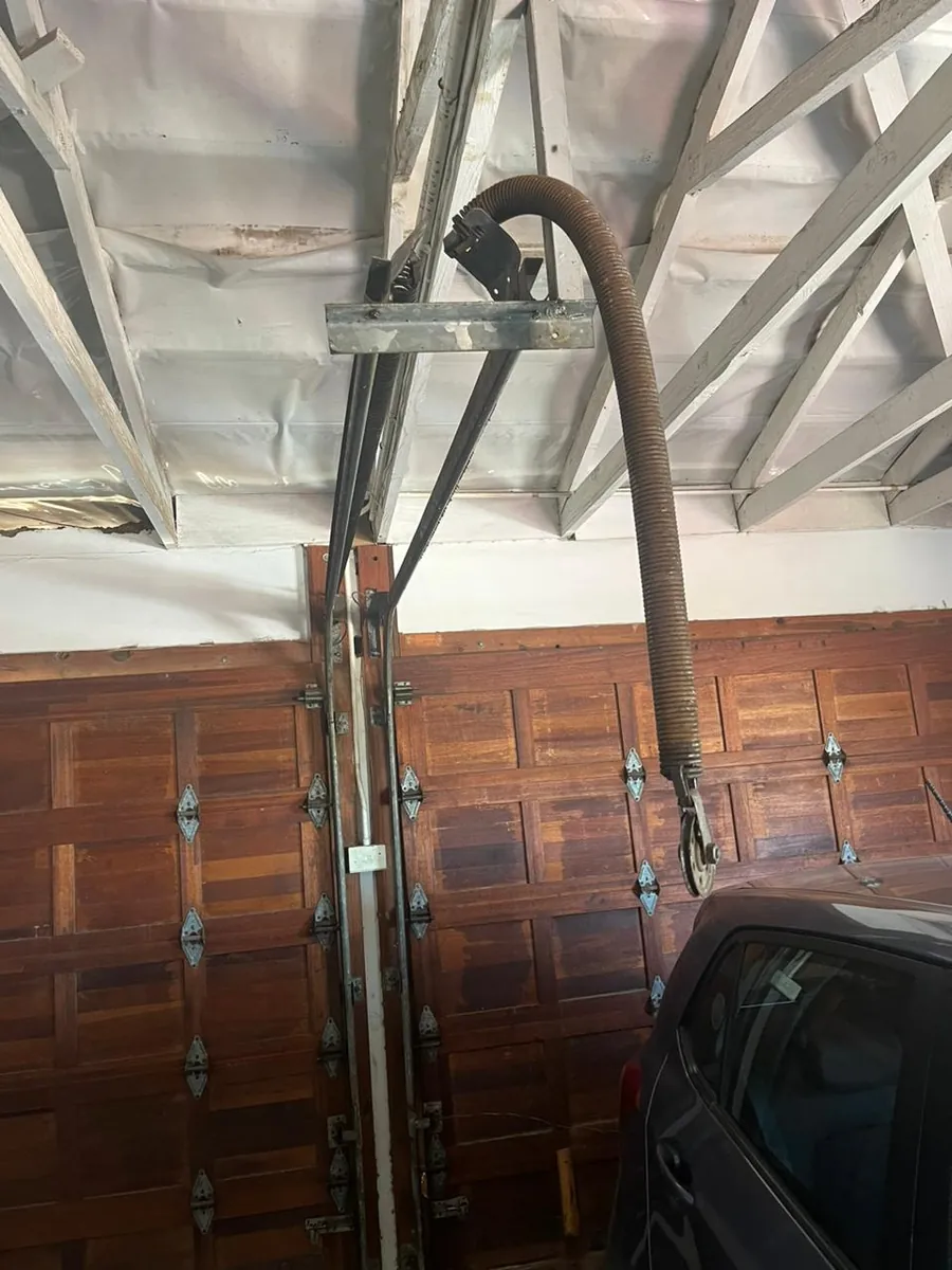 Wooden sectional garage door and overhead track
